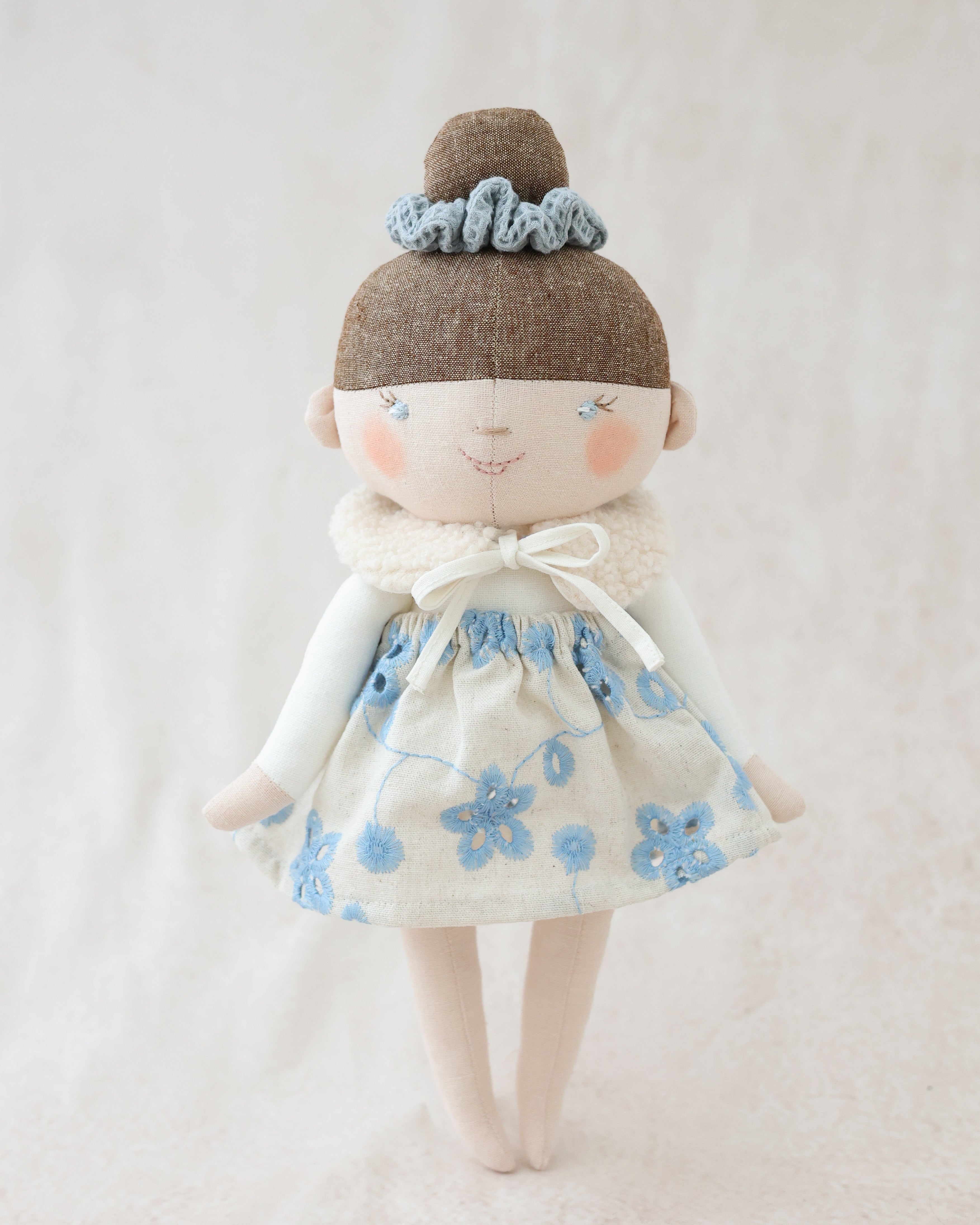Classic Doll Bun Hairstyle and Blue Skirt