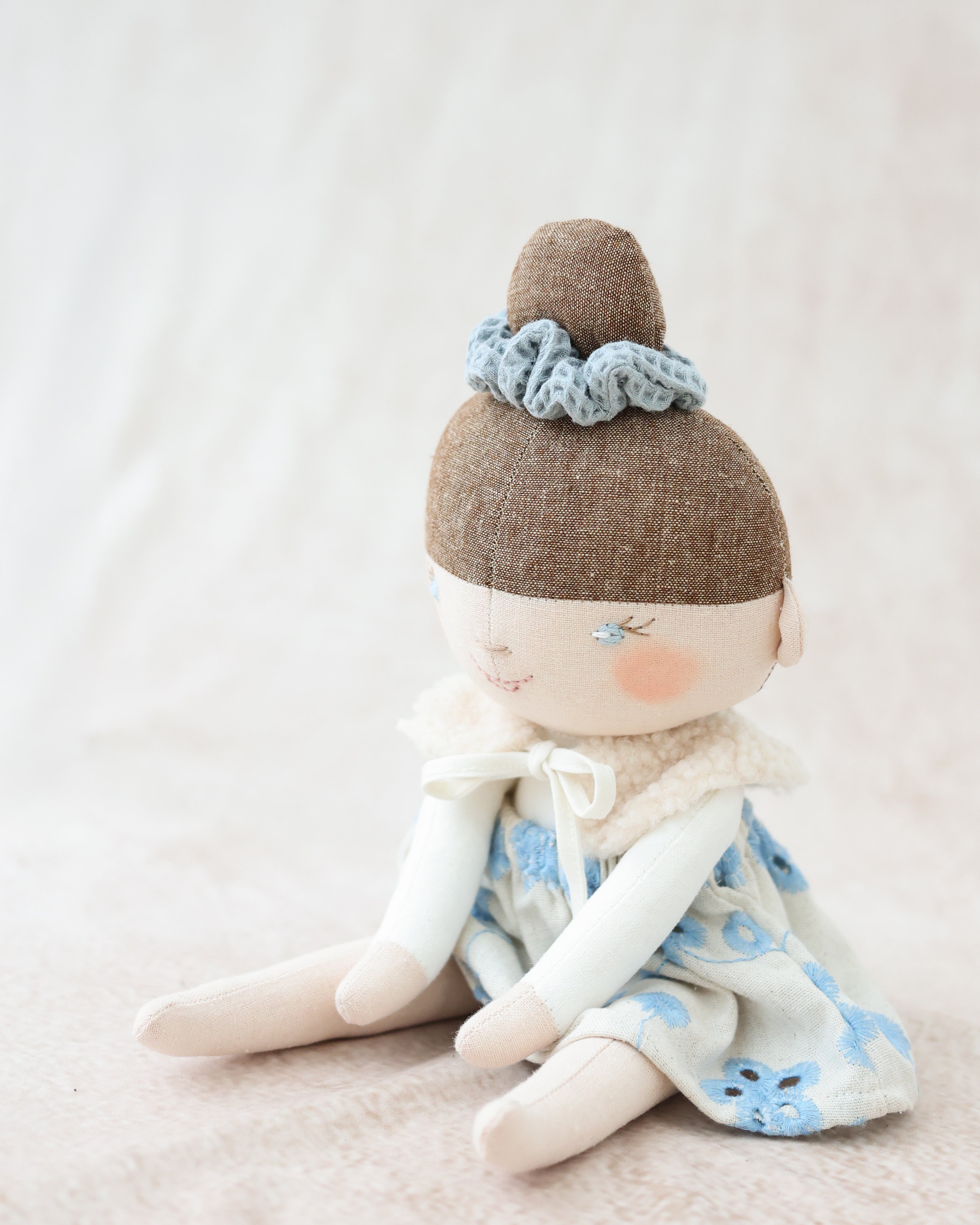 Classic Doll Bun Hairstyle and Blue Skirt